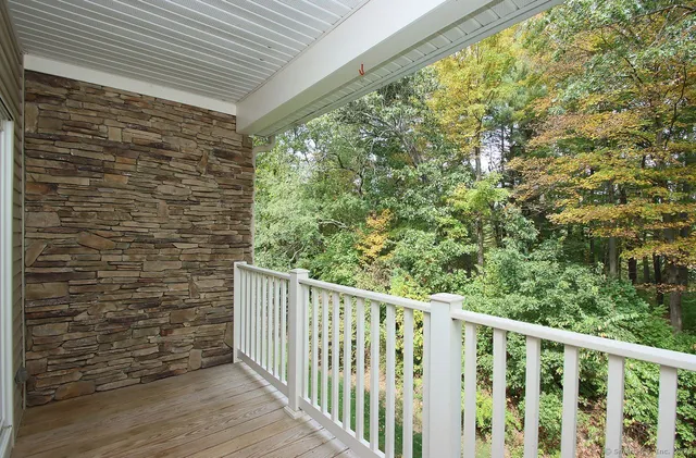 a view of a balcony with wooden floor