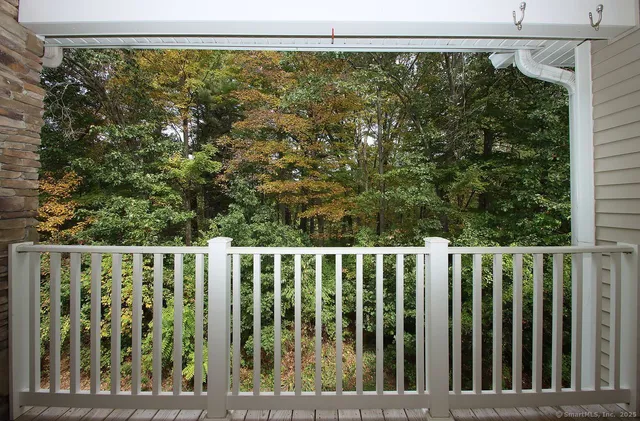a view of a yard with wooden fence