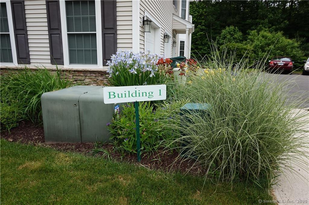 35 Todd Street, Unit 103 Hamden, CT 06518 - Photo 39 of 40 a sign that is sitting in front of a house with plants and trees
