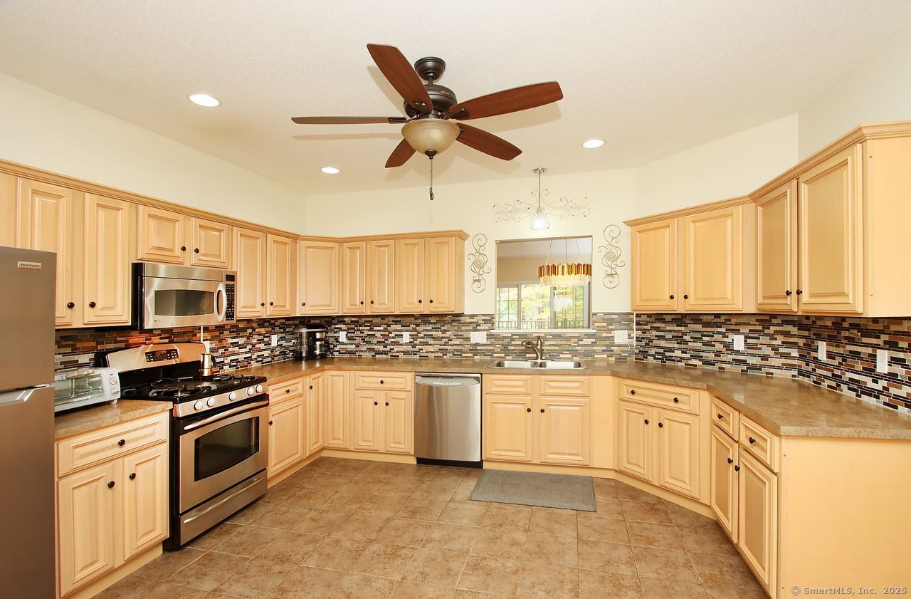 35 Todd Street, Unit 103 Hamden, CT 06518 - Photo 10 of 40 a kitchen with stainless steel appliances a stove sink microwave and cabinets