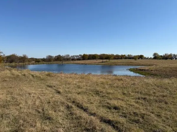 a view of a lake with houses in the back