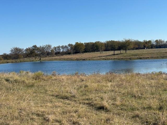 124.75-ac Donald Road Krum, TX 76249 - Photo 5 of 13 a view of a lake with houses in the background