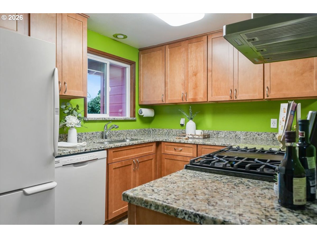 2035 Primrose Loop Philomath, OR 97370 - Photo 35 of 48 a kitchen with a stove a sink and a wooden cabinets