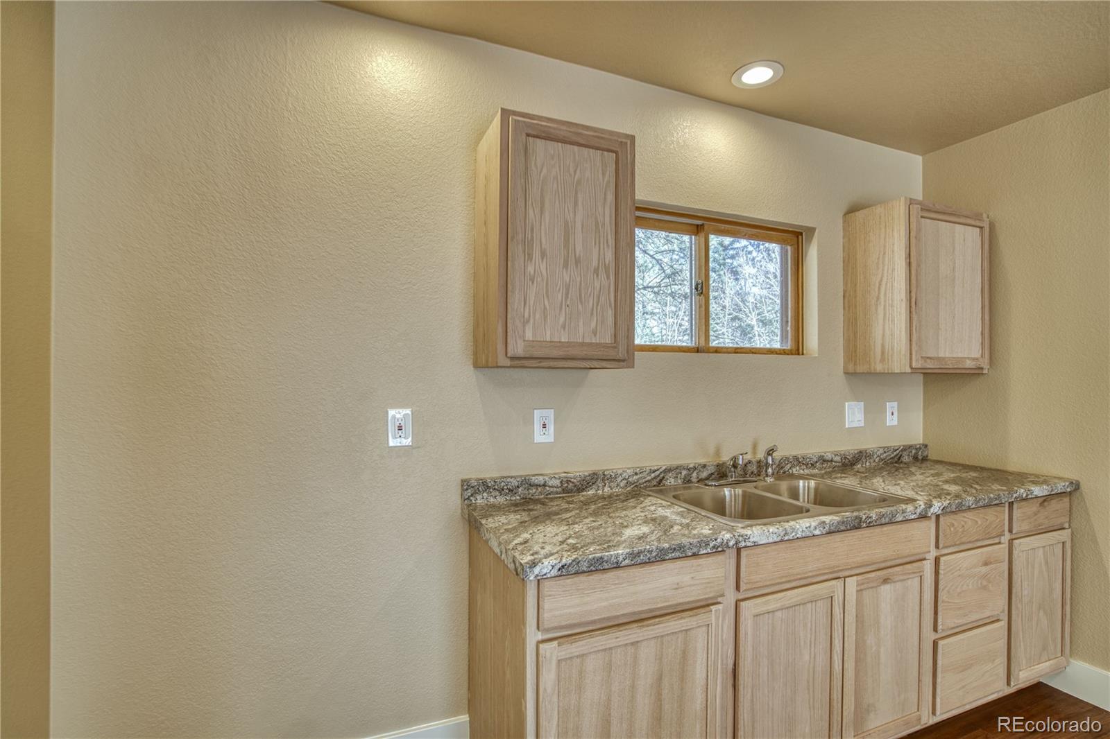 236 Rustic Road Bellvue, CO 80512 - Photo 19 of 27 a bathroom with a granite countertop sink and a vanity