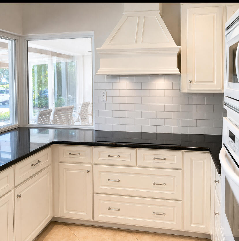 1111 Pepperridge Terrace Boca Raton, FL 33486 - Photo 7 of 8 a kitchen with granite countertop white cabinets and sink