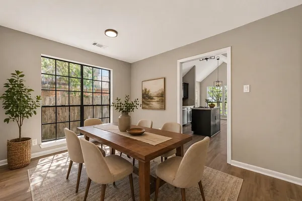 a view of a dining room with furniture window and wooden floor