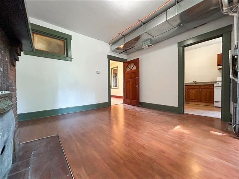 219 Brownsville Road Pittsburgh, PA 15210 - Photo 13 of 30 a view of a livingroom with wooden floor and staircase