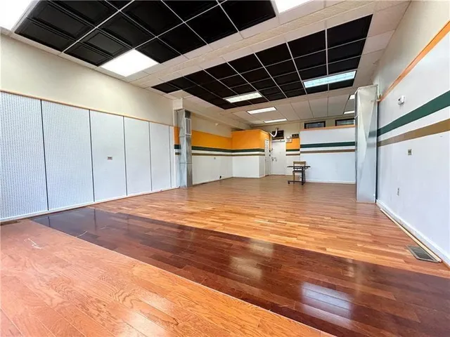 a view of a room with wooden floor