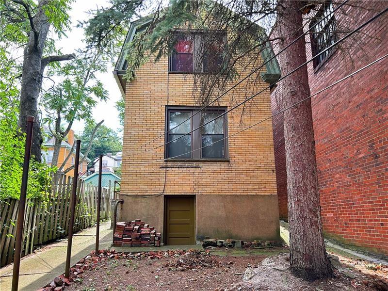 219 Brownsville Road Pittsburgh, PA 15210 - Photo 5 of 30 a brick building with a bench and trees