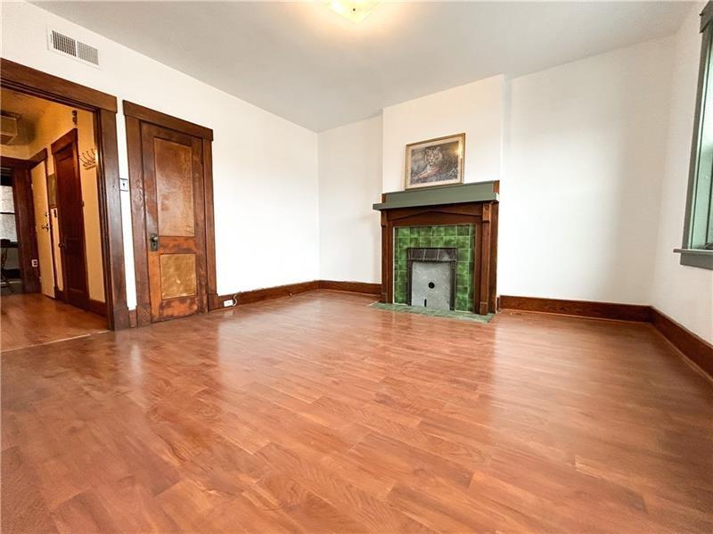 219 Brownsville Road Pittsburgh, PA 15210 - Photo 6 of 30 a view of an empty room with wooden floor and a window