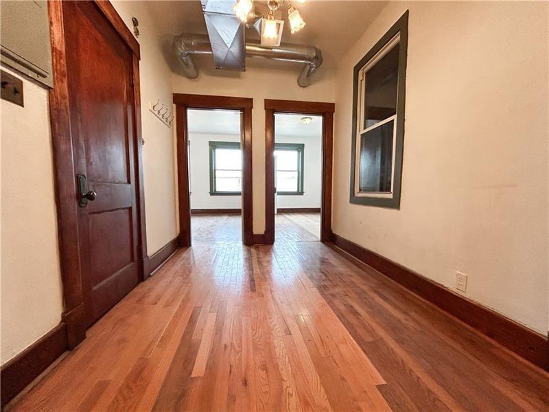 219 Brownsville Road Pittsburgh, PA 15210 - Photo 8 of 30 a view of livingroom with hardwood floor and hallway
