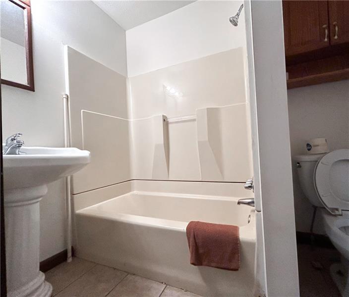 219 Brownsville Road Pittsburgh, PA 15210 - Photo 9 of 30 a bathroom with a sink a toilet and a mirror