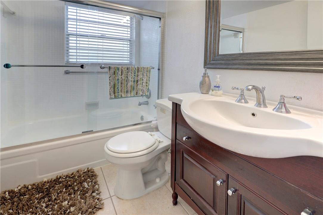 144 Dorset D, Unit 144 Boca Raton, FL 33434 - Photo 11 of 20 a bathroom with a sink a toilet and a mirror