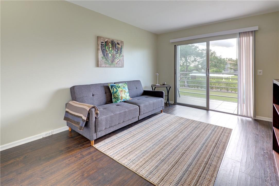 144 Dorset D, Unit 144 Boca Raton, FL 33434 - Photo 13 of 20 a living room with couch and a large window