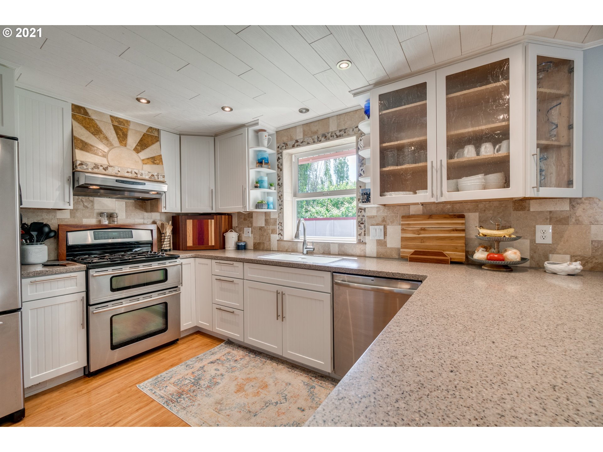 3132 1st Street Hubbard, OR 97032 - Photo 12 of 32 a kitchen with stainless steel appliances granite countertop a stove a sink and a microwave