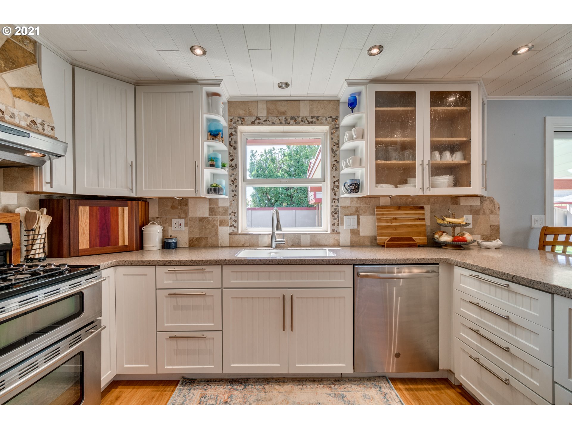 3132 1st Street Hubbard, OR 97032 - Photo 13 of 32 a kitchen with cabinets appliances and a window