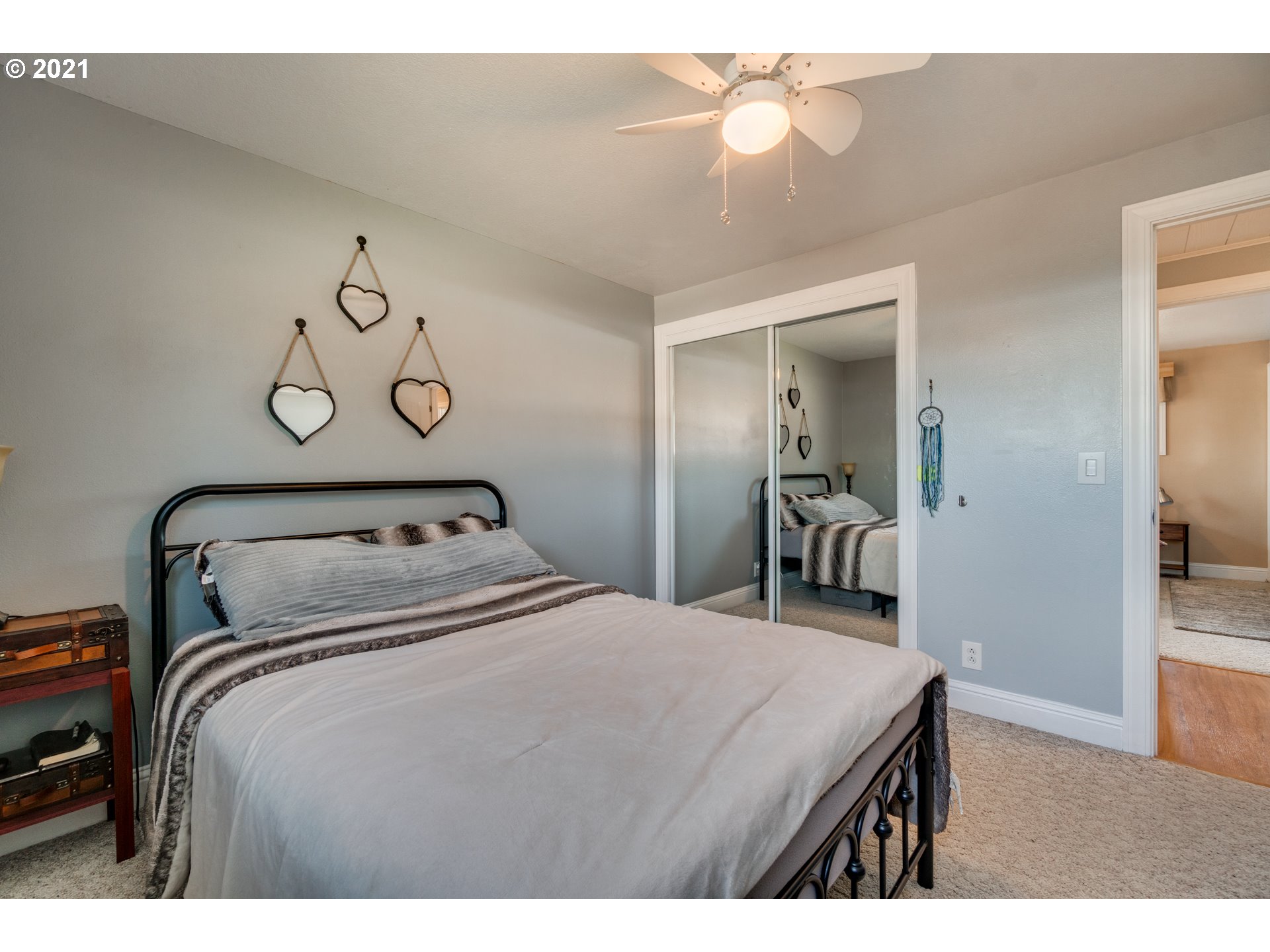 3132 1st Street Hubbard, OR 97032 - Photo 17 of 32 a bedroom with a bed and a chandelier