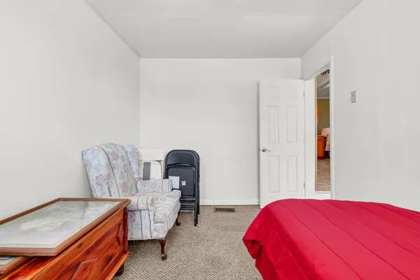 a bedroom with bed and cabinet