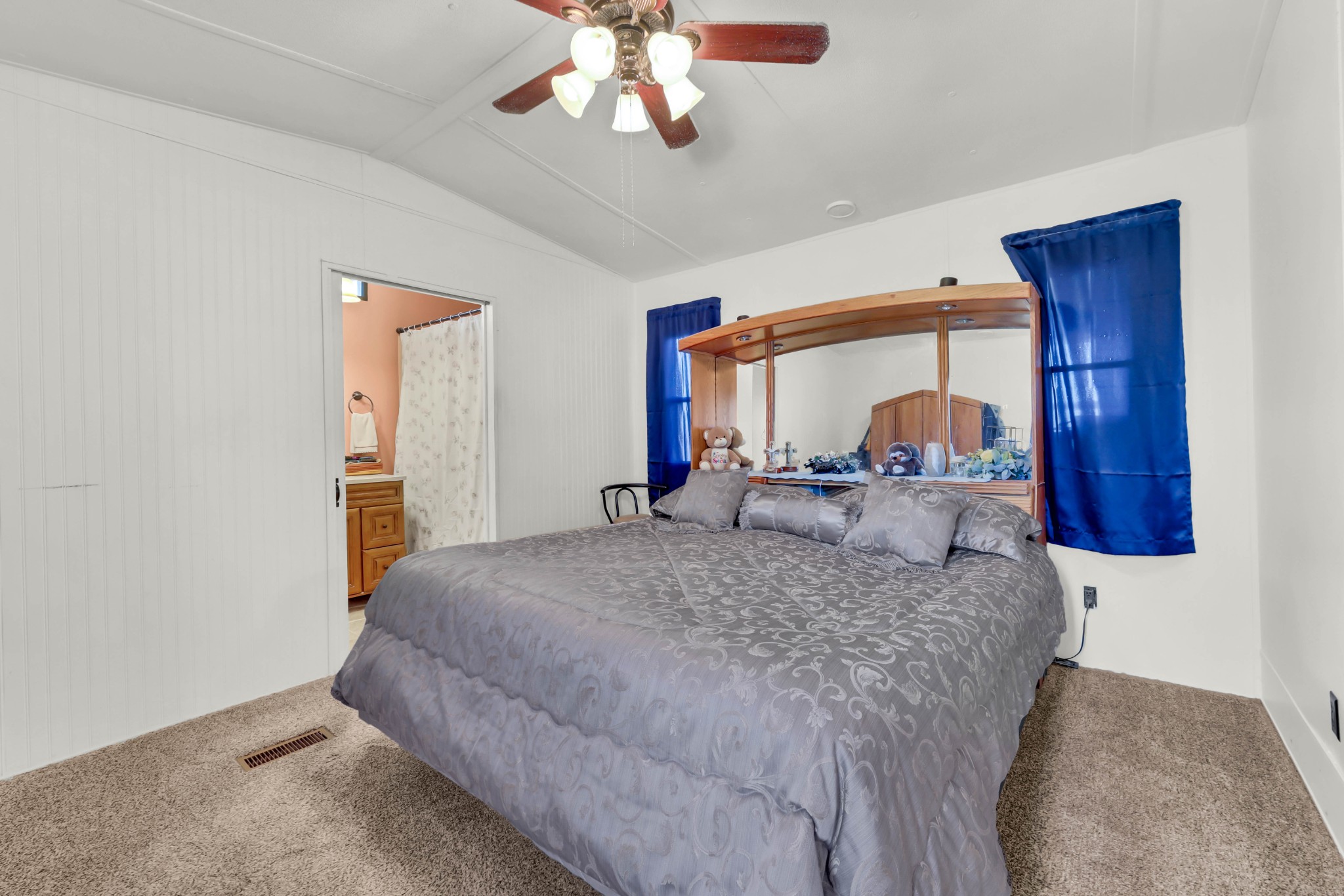 1765 Woolworth Road Erin, TN 37061 - Photo 12 of 34 a bedroom with a large bed and a chandelier