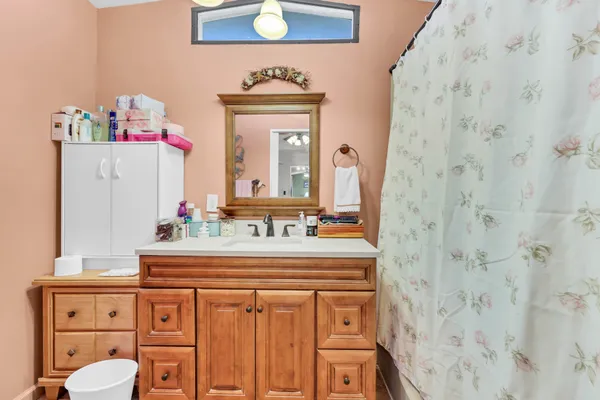 a bathroom with a sink vanity mirror and toilet