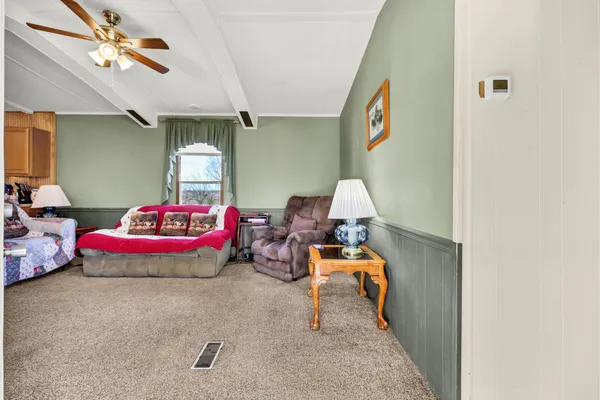 a bedroom with furniture and a chandelier
