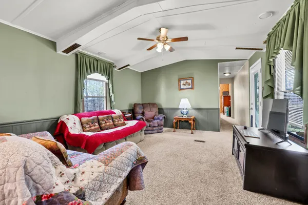 a bedroom with furniture and a chandelier