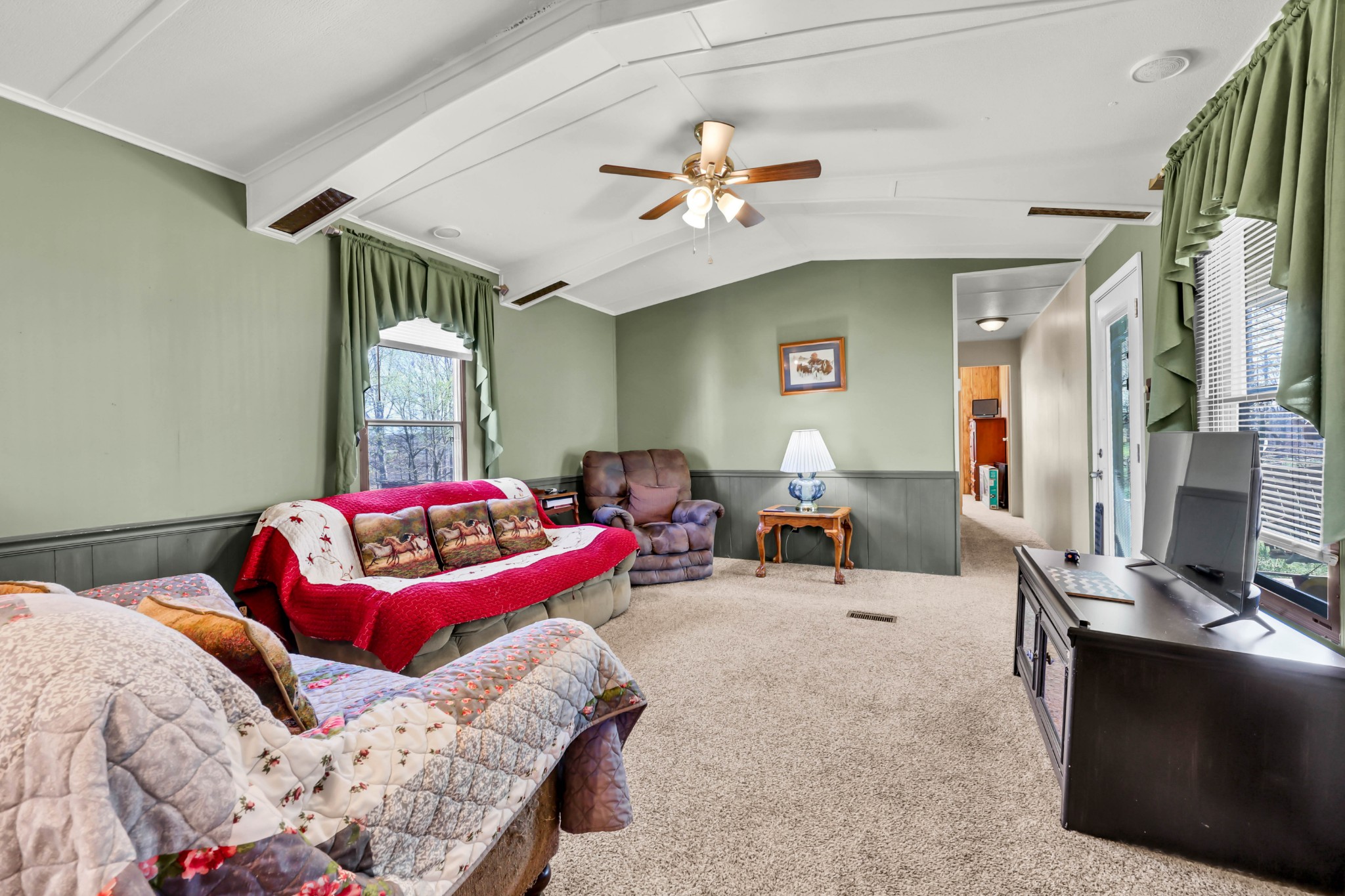 1765 Woolworth Road Erin, TN 37061 - Photo 4 of 34 a bedroom with furniture and a chandelier