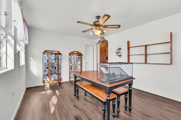 a living room with pool table a window and a ceiling fan