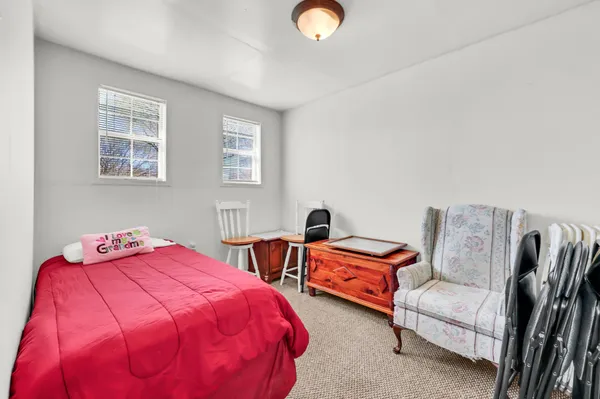 a bedroom with two beds and a window