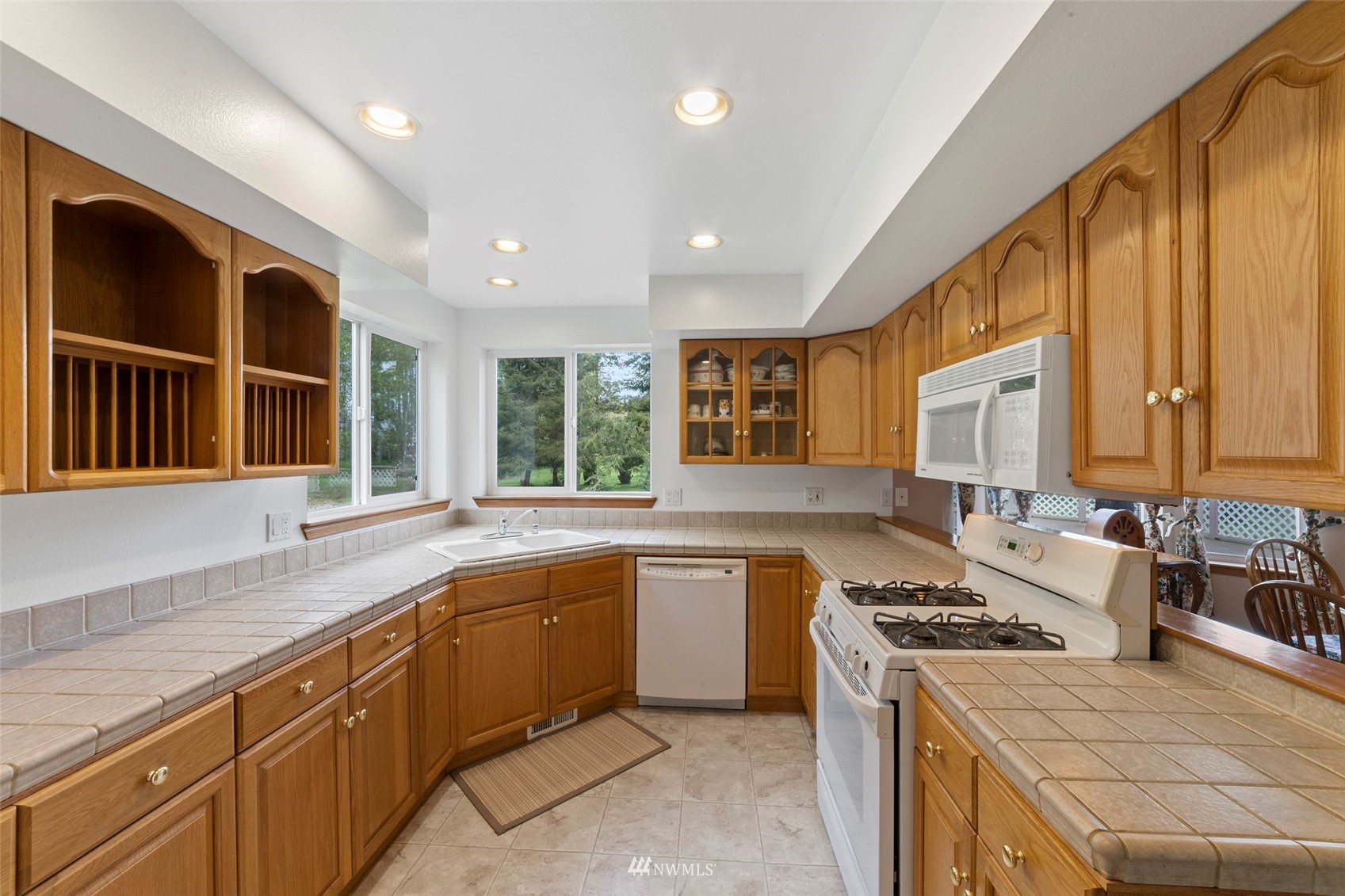 7511 Ham Road Ferndale, WA 98248 - Photo 13 of 40 a kitchen with a sink stove top oven and cabinets
