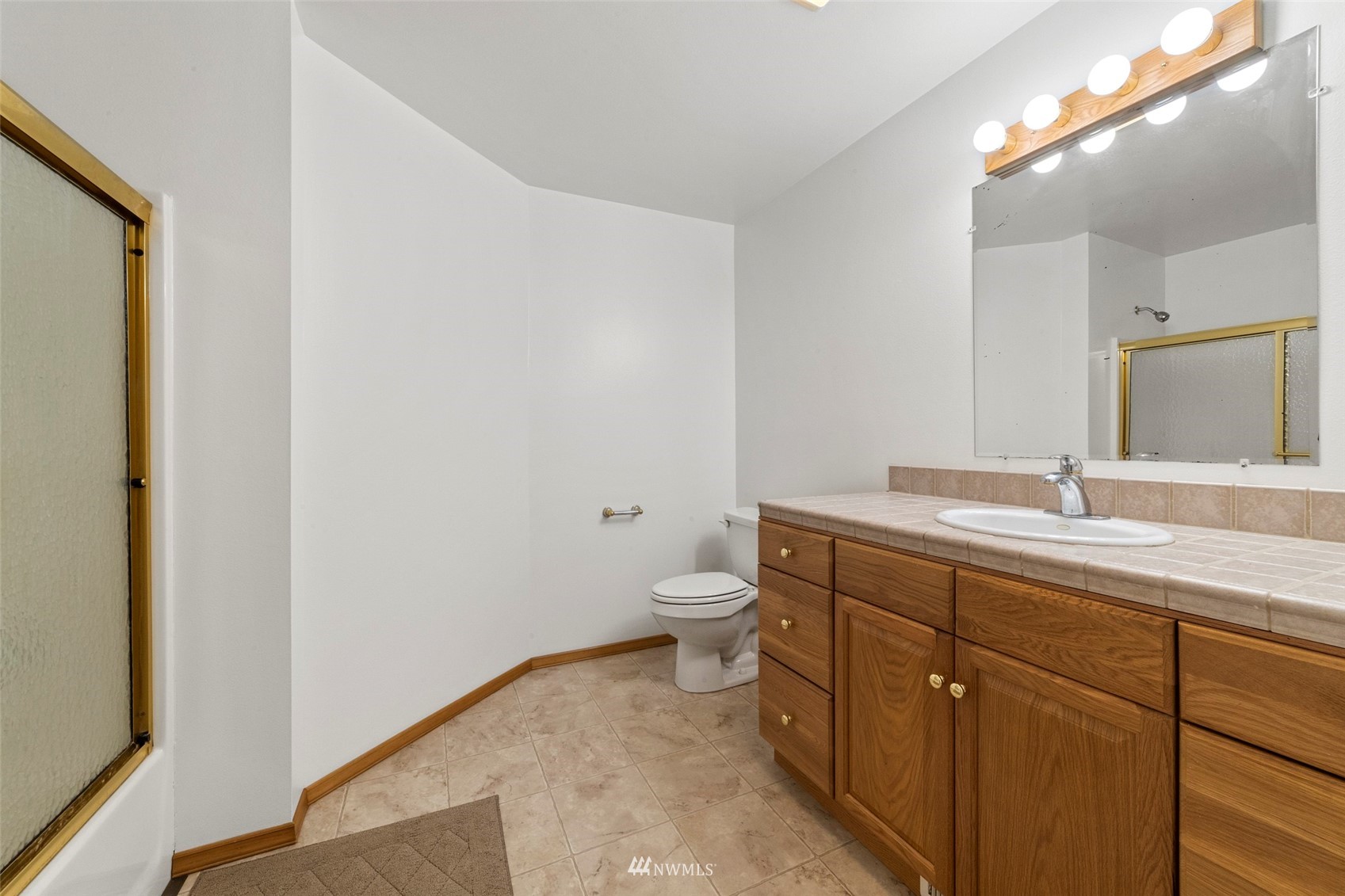 7511 Ham Road Ferndale, WA 98248 - Photo 24 of 40 a bathroom with a granite countertop sink a toilet and a mirror