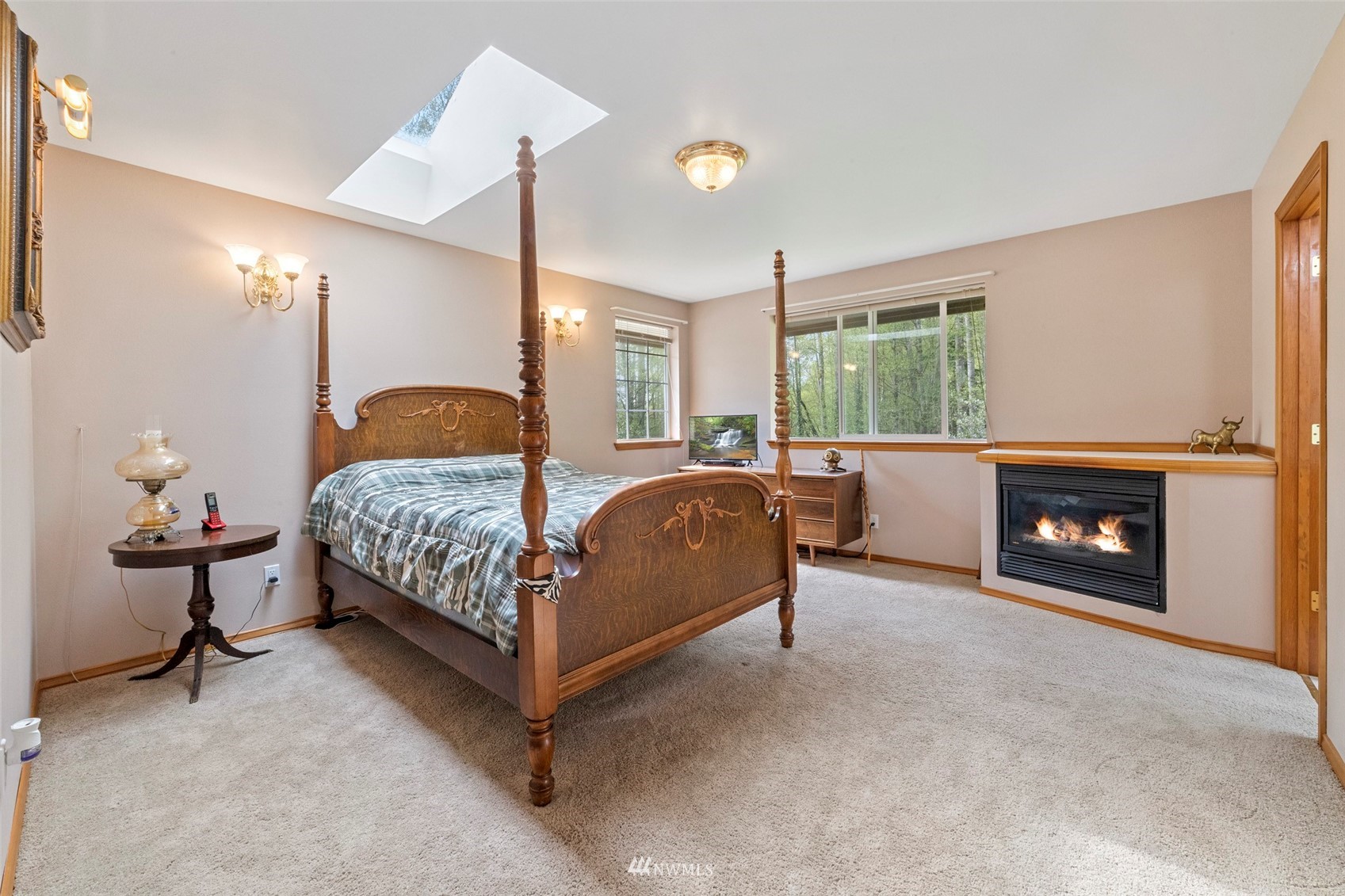 7511 Ham Road Ferndale, WA 98248 - Photo 25 of 40 a bedroom with a bed and a fireplace