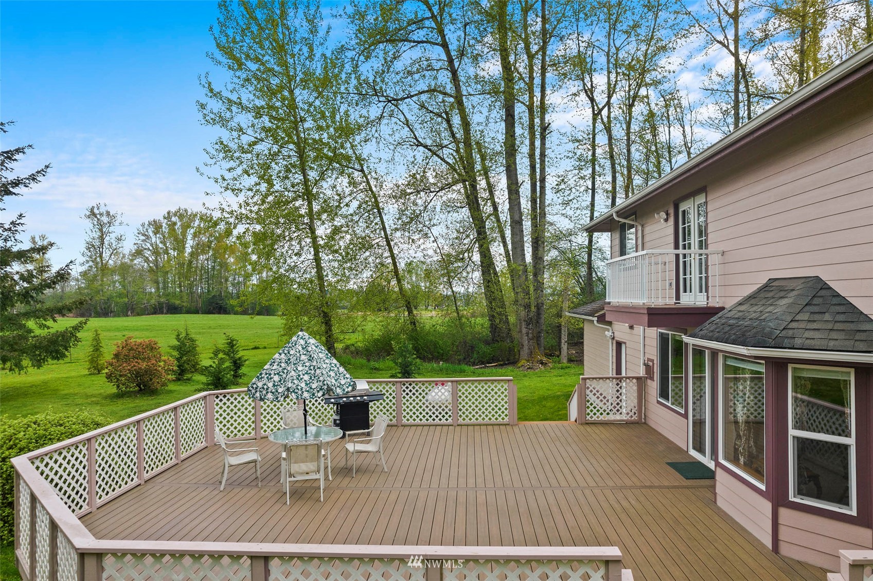7511 Ham Road Ferndale, WA 98248 - Photo 31 of 40 a patio with table and chairs and potted plants with wooden floor and fence