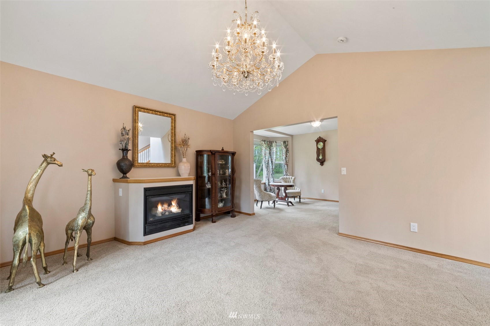 7511 Ham Road Ferndale, WA 98248 - Photo 9 of 40 a view of a livingroom with a fireplace and a chandelier