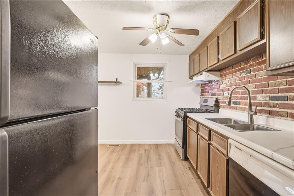 1425 Swede Hill Road Greensburg, PA 15601 - Photo 14 of 42 a kitchen with stainless steel appliances granite countertop a refrigerator a sink dishwasher and a stove