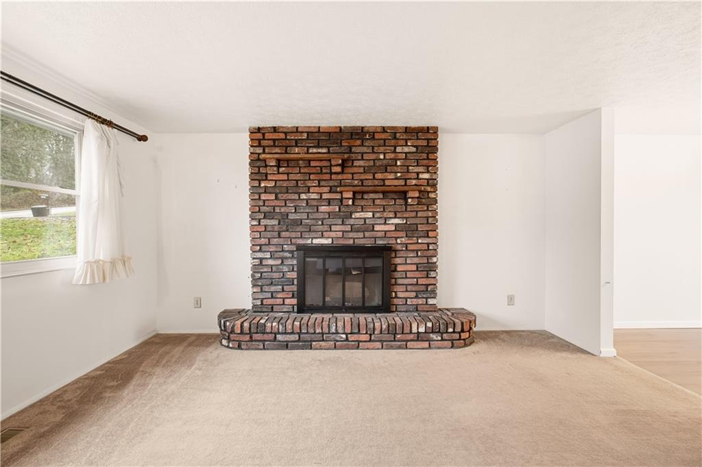 1425 Swede Hill Road Greensburg, PA 15601 - Photo 7 of 42 a view of empty room with a fireplace