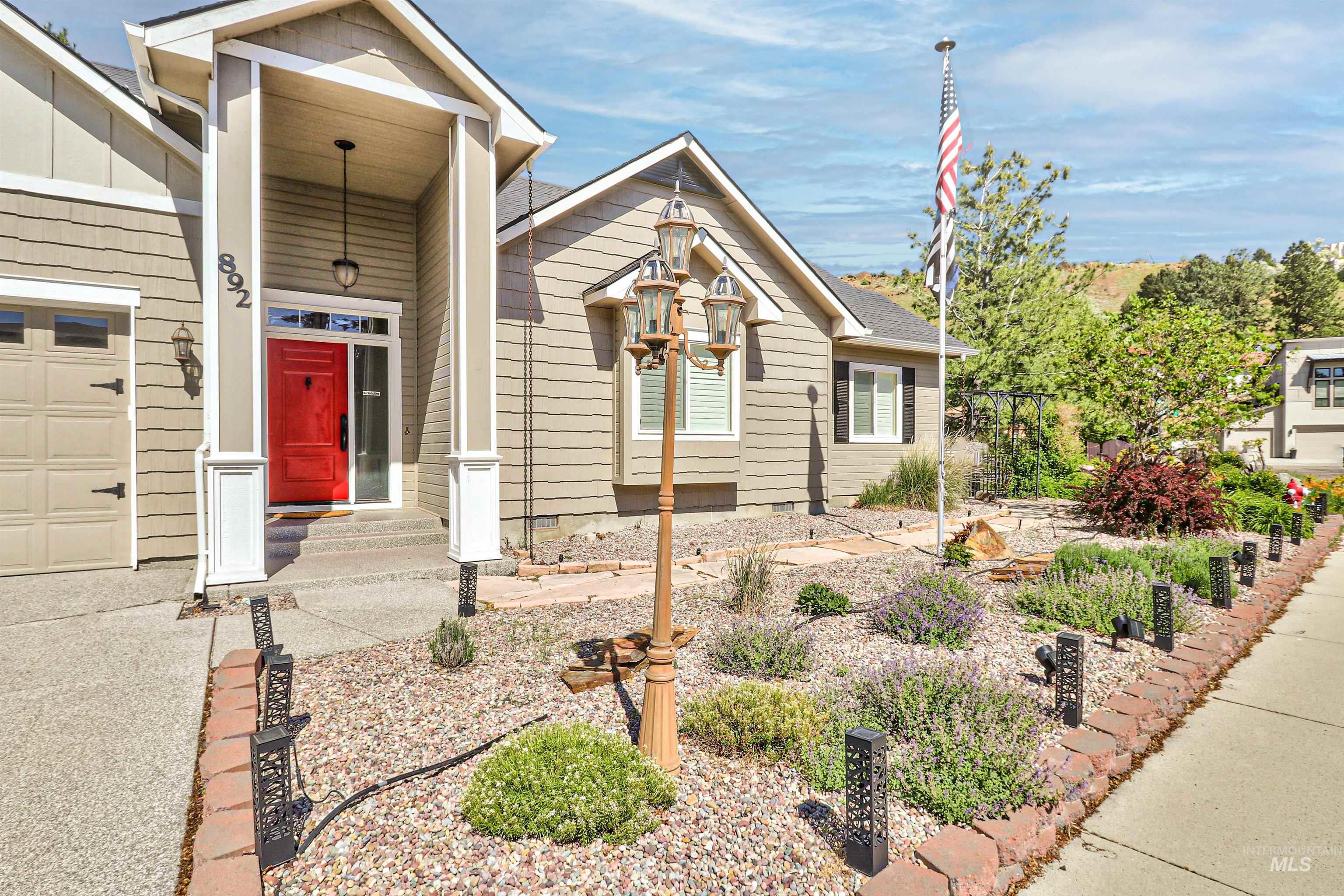 892 South Capitola Way Boise, ID 83712 - Photo 3 of 34 Contemporary exterior featuring horizontal siding and a prominent red entry door