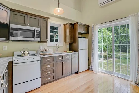 a kitchen with stainless steel appliances granite countertop a refrigerator and a sink