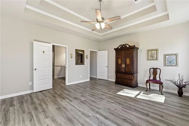 a view of a livingroom with wooden floor and furniture