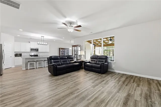 a living room with furniture and kitchen view