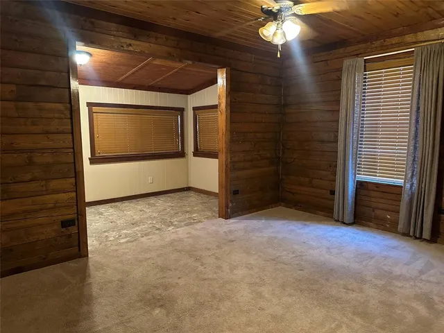 a view of an empty room with a ceiling fan