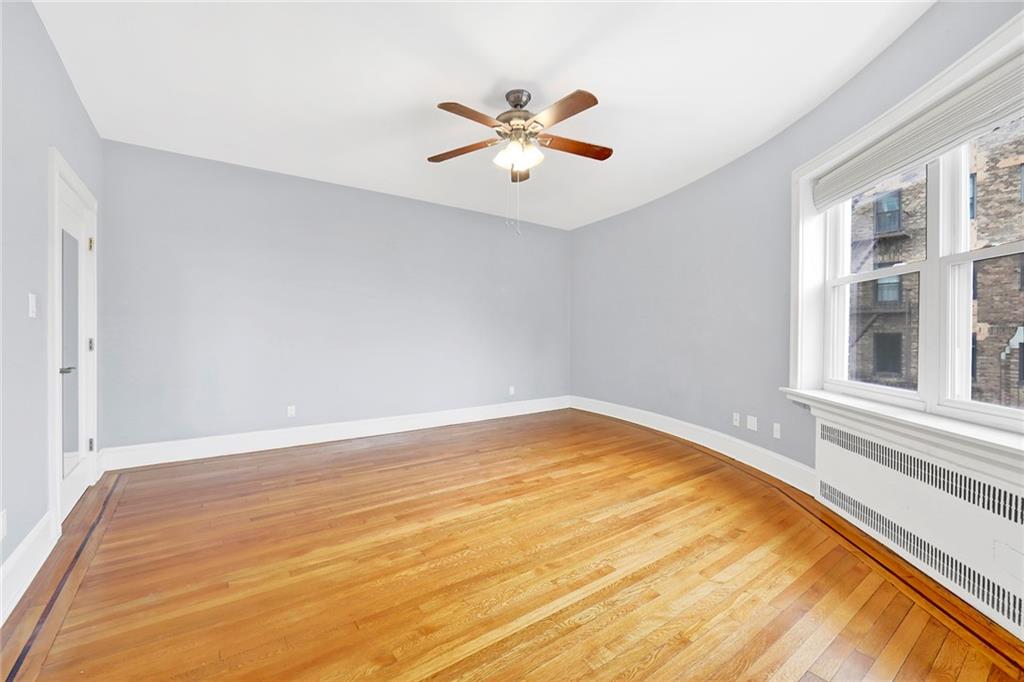 9615 Shore Road, Unit 3A Brooklyn, NY 11209 - Photo 12 of 14 wooden floor in an empty room with a window