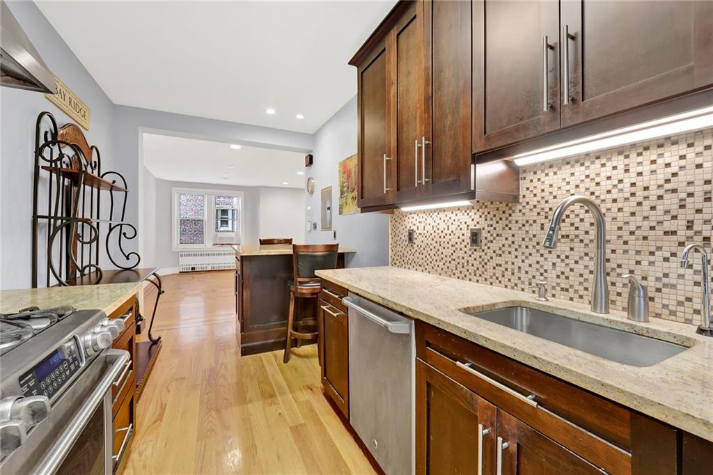 9615 Shore Road, Unit 3A Brooklyn, NY 11209 - Photo 4 of 14 a kitchen with a sink stove and cabinets