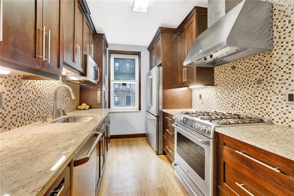 9615 Shore Road, Unit 3A Brooklyn, NY 11209 - Photo 5 of 14 a kitchen with a stove and a sink
