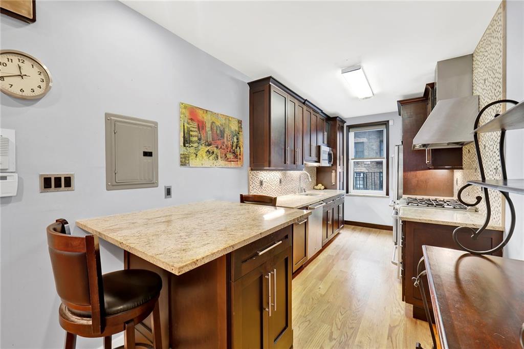 9615 Shore Road, Unit 3A Brooklyn, NY 11209 - Photo 6 of 14 a view of a kitchen area with furniture and wooden floor