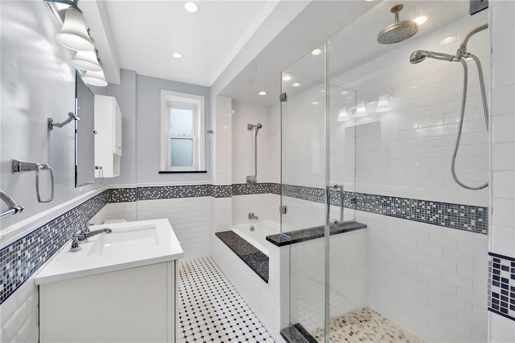 9615 Shore Road, Unit 3A Brooklyn, NY 11209 - Photo 9 of 14 a bathroom with a tub a sink and a shower