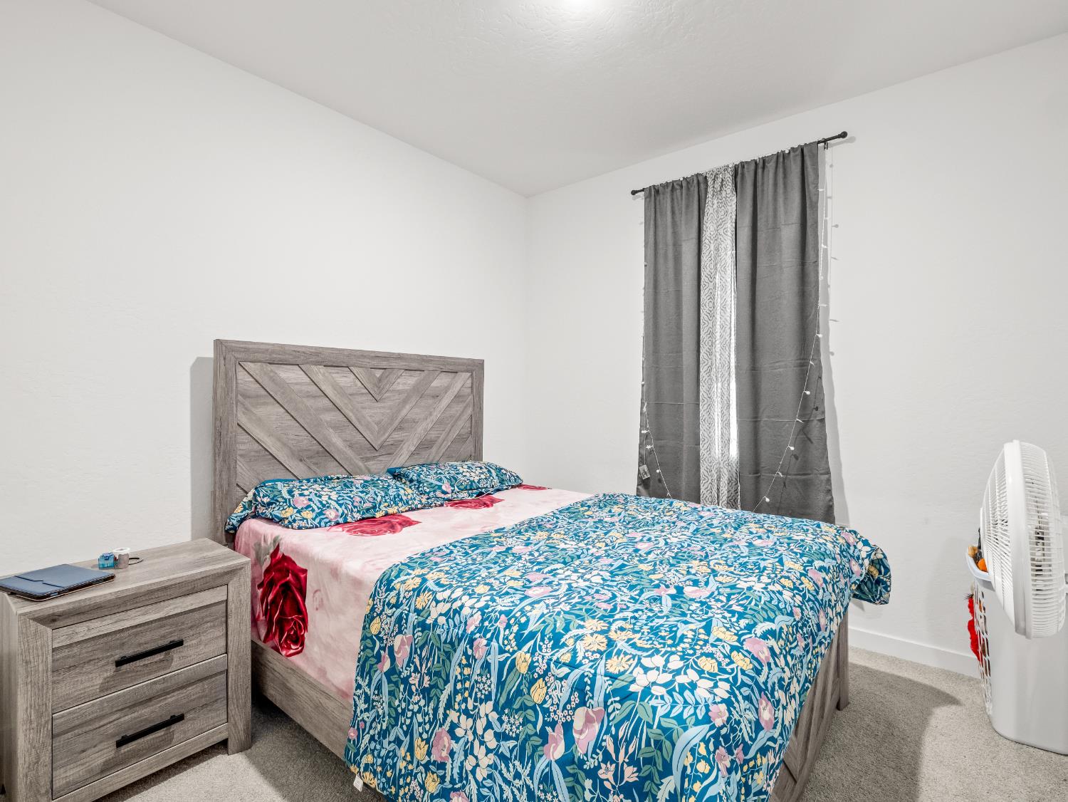 5958 West Austin Way Fresno, CA 93722 - Photo 12 of 18 a bedroom with a bed and a window