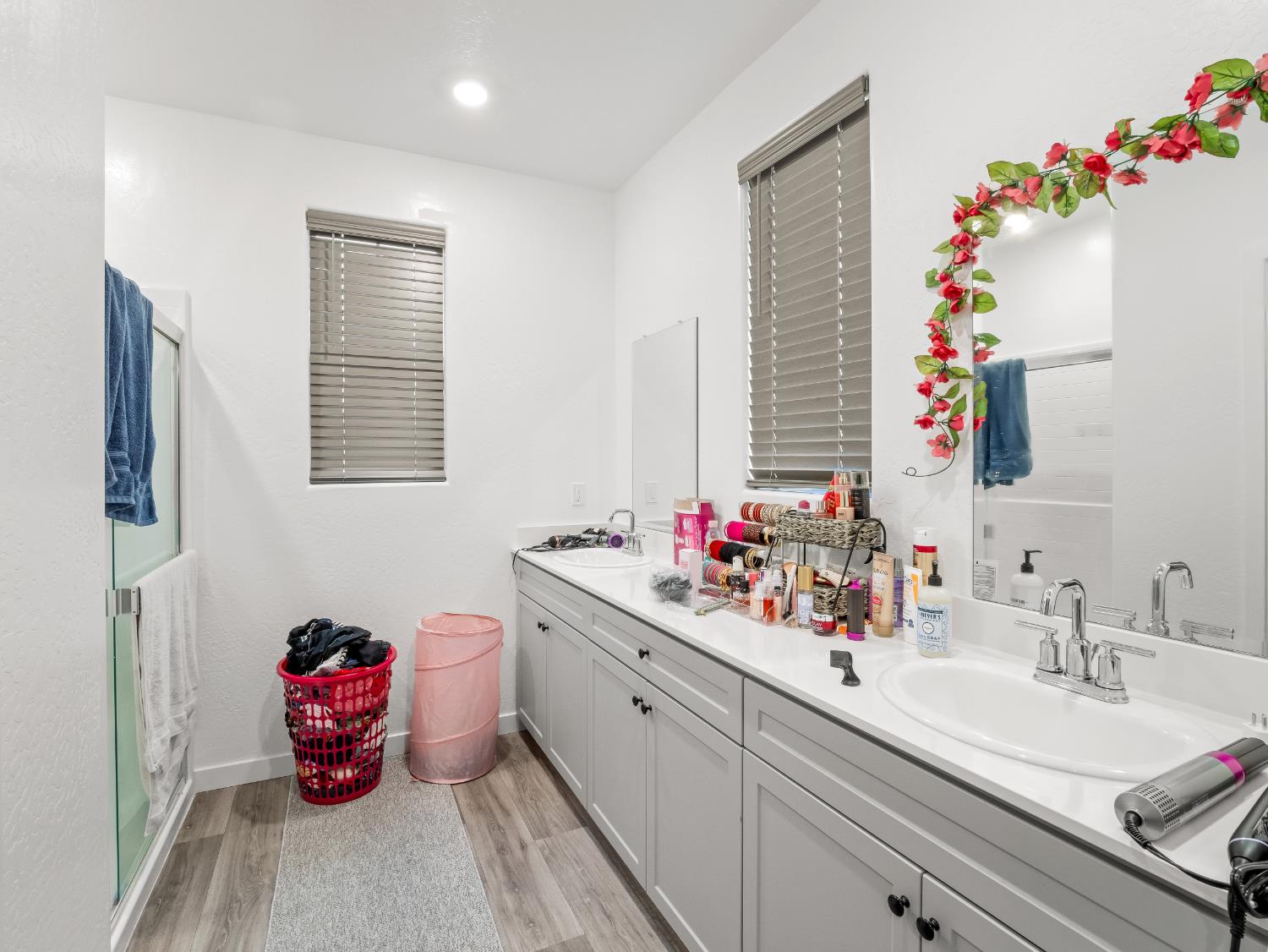 5958 West Austin Way Fresno, CA 93722 - Photo 13 of 18 a bathroom with a sink mirror and window
