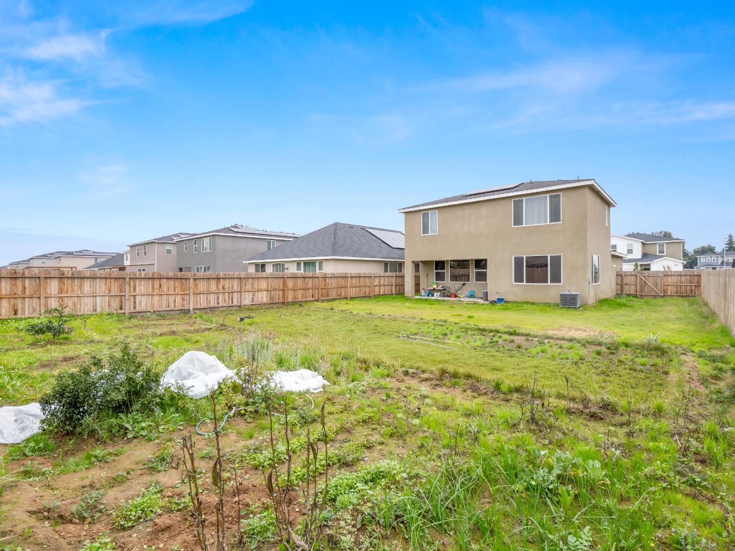 5958 West Austin Way Fresno, CA 93722 - Photo 2 of 18 a view of a house with a big yard