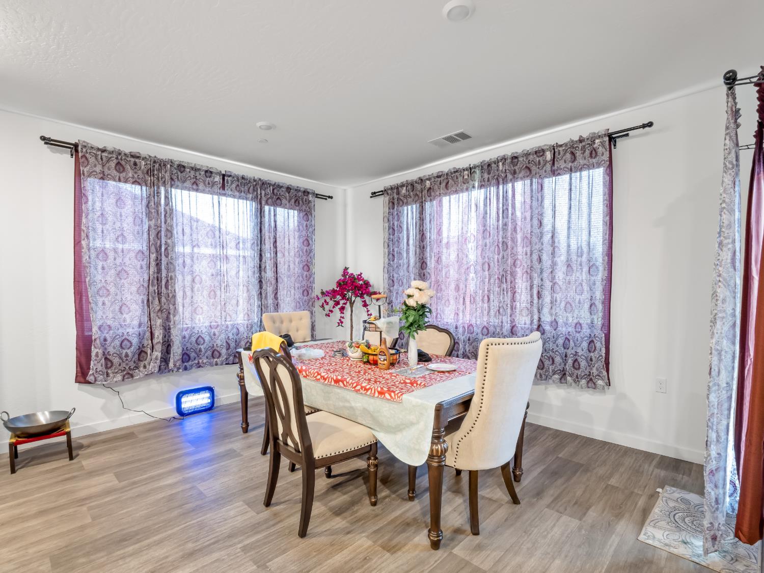 5958 West Austin Way Fresno, CA 93722 - Photo 9 of 18 a dining room with furniture and wooden floor